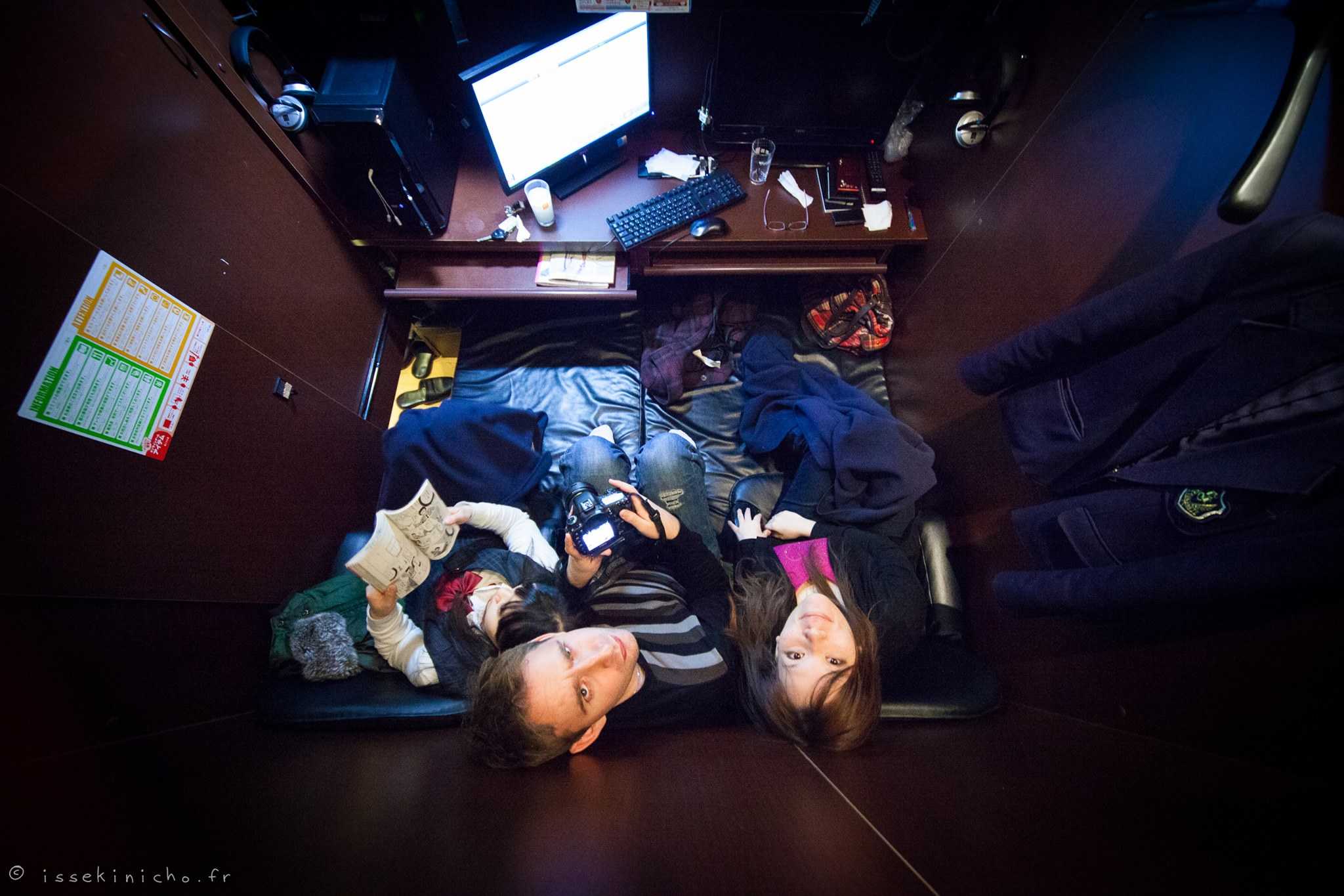 Restful intimacy in cluttered bedroom with sleeping couple, highlighting privacy and exhaustion.