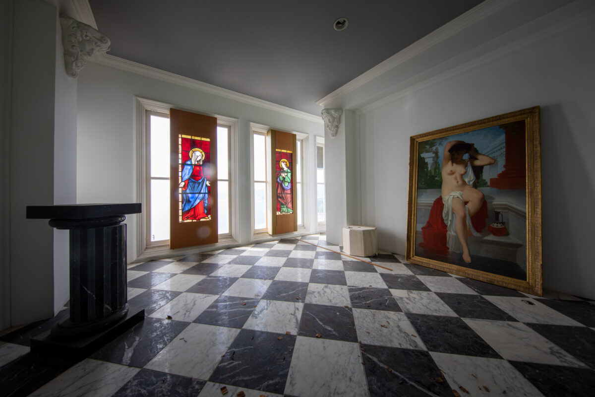 Marugen Mansion grand hall with marble checkerboard floor, stained glass doors, and classic painting
