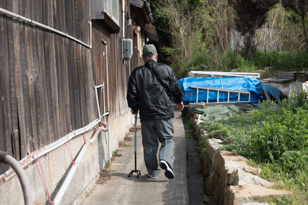 Aging residents solitary path, Manabe-shimas rural isolation.