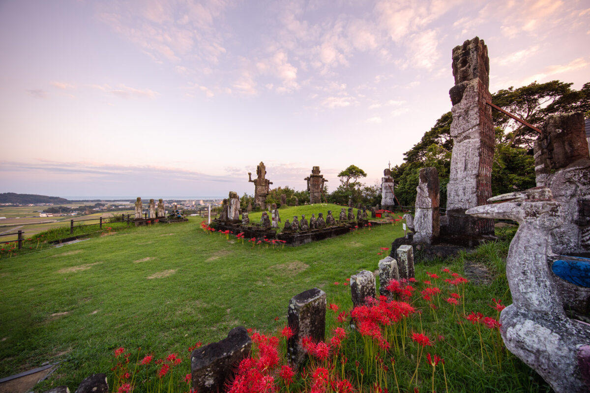 Serene rural landscape, ancient stone sculptures, vibrant poppies.
