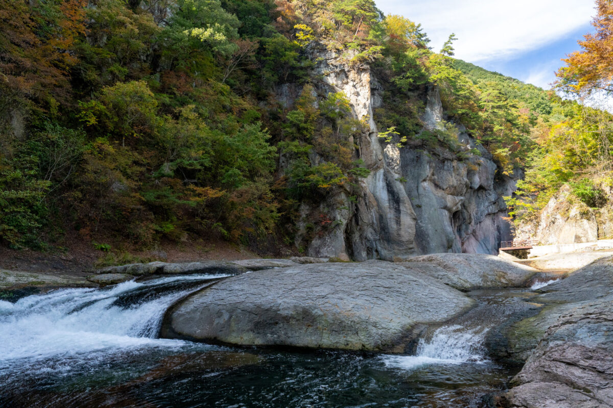 Fukiware Falls in Gunma, Japan, wide river cascades over smooth rock gorge