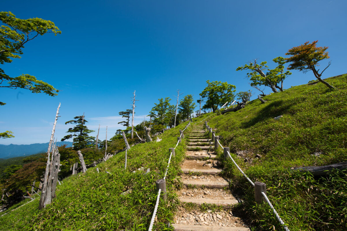 Stone-step hiking trail on Mount Ōdaigahara, Japan, under clear blue sky