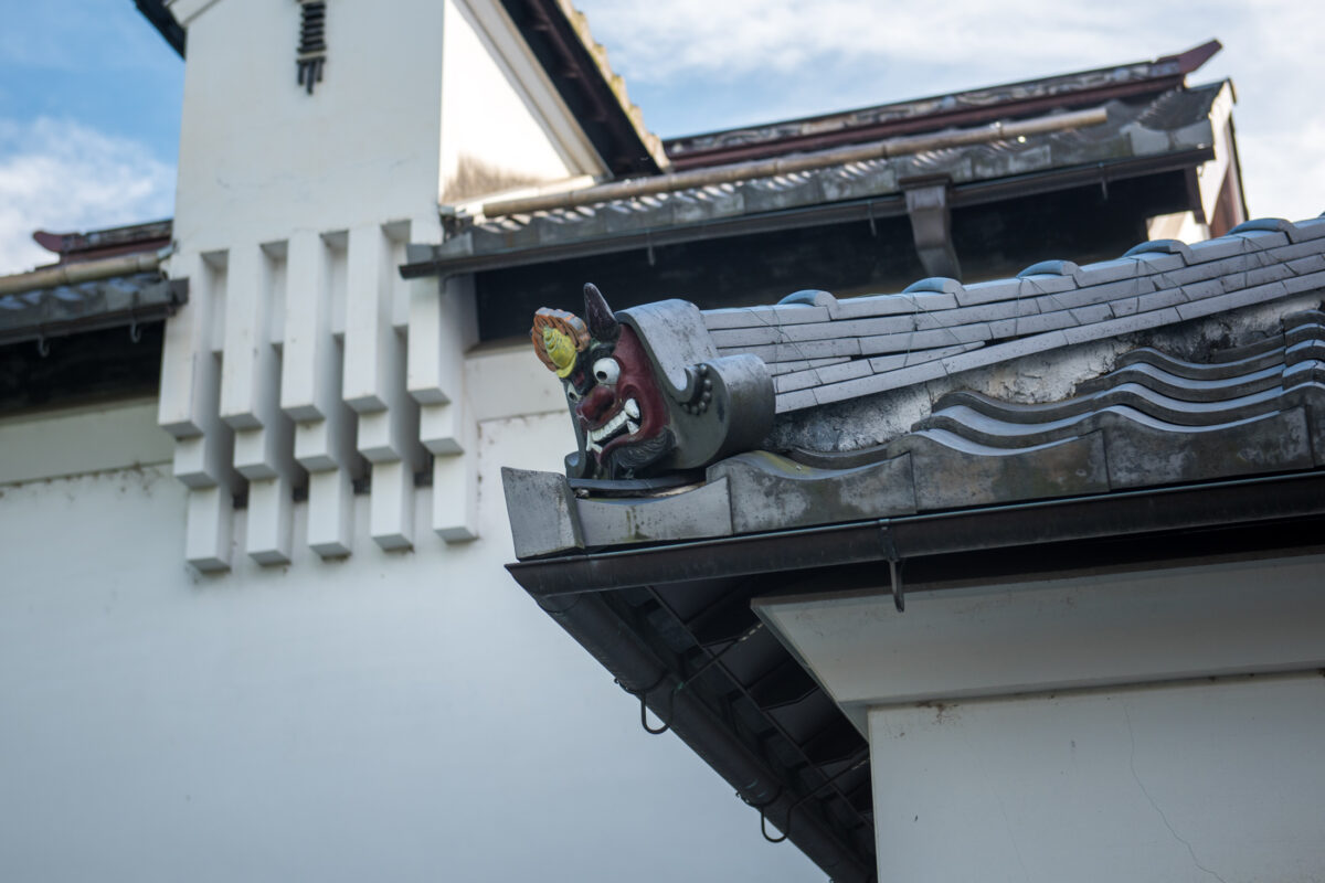 Traditional Japanese tiled roof corner with guardian oni ornament in Omihachiman, Shiga